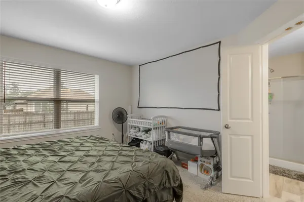 a bedroom with furniture and a window