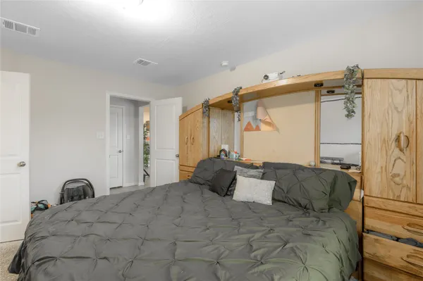 a bedroom with a bed and a mirror