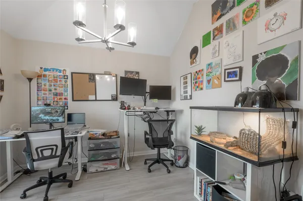 a view of a workspace with furniture and a window