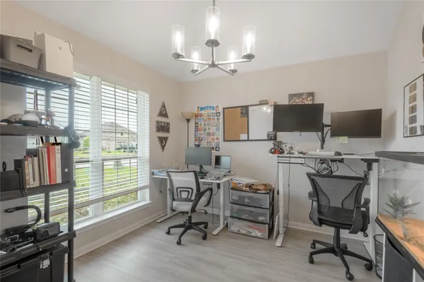 a view of a workspace with furniture and a window