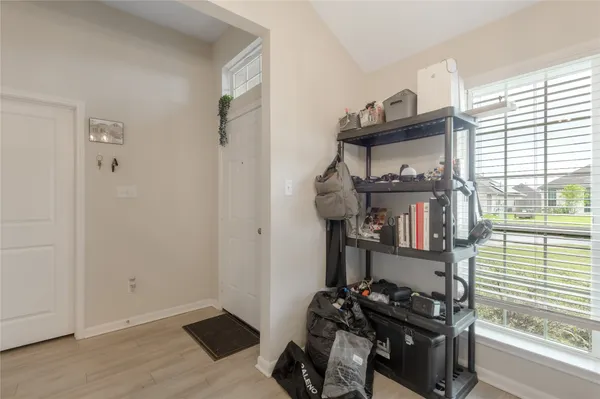 a room with lots of books and a window