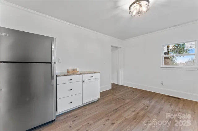 a view of a refrigerator in kitchen and wooden floor