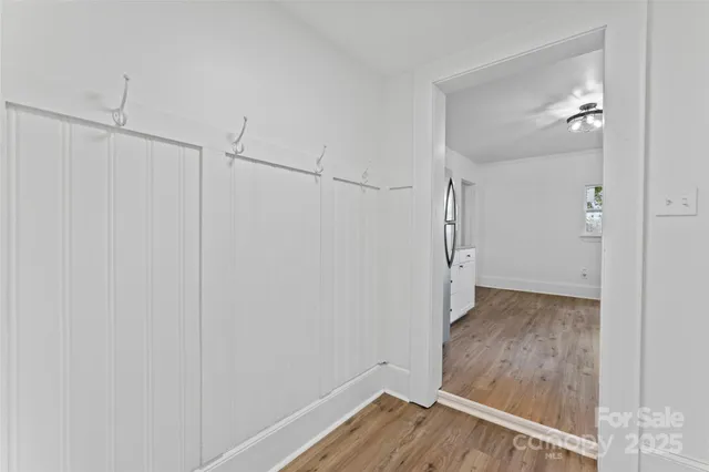 a view of a hallway with wooden floor