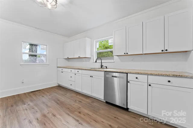a kitchen with granite countertop white cabinets and white appliances