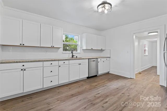 a view of cabinets a sink and dishwasher in a kitchen