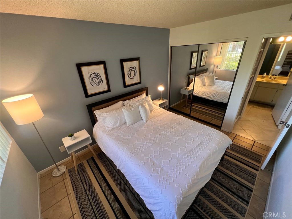 69646 Antonia Way Rancho Mirage, CA 92270 - Photo 17 of 50 a bedroom with a bed and a flat tv screen on a dresser