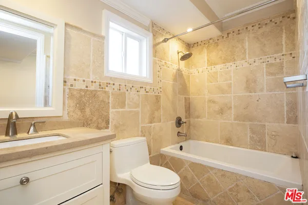 a view of a bathroom with a shower and wooden floor