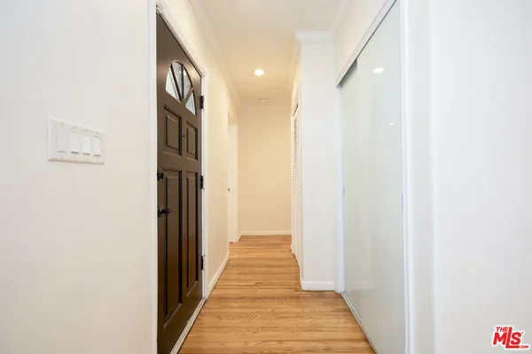 a view of a hallway with wooden floor