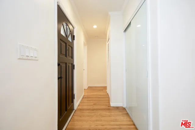 a view of a hallway with wooden floor