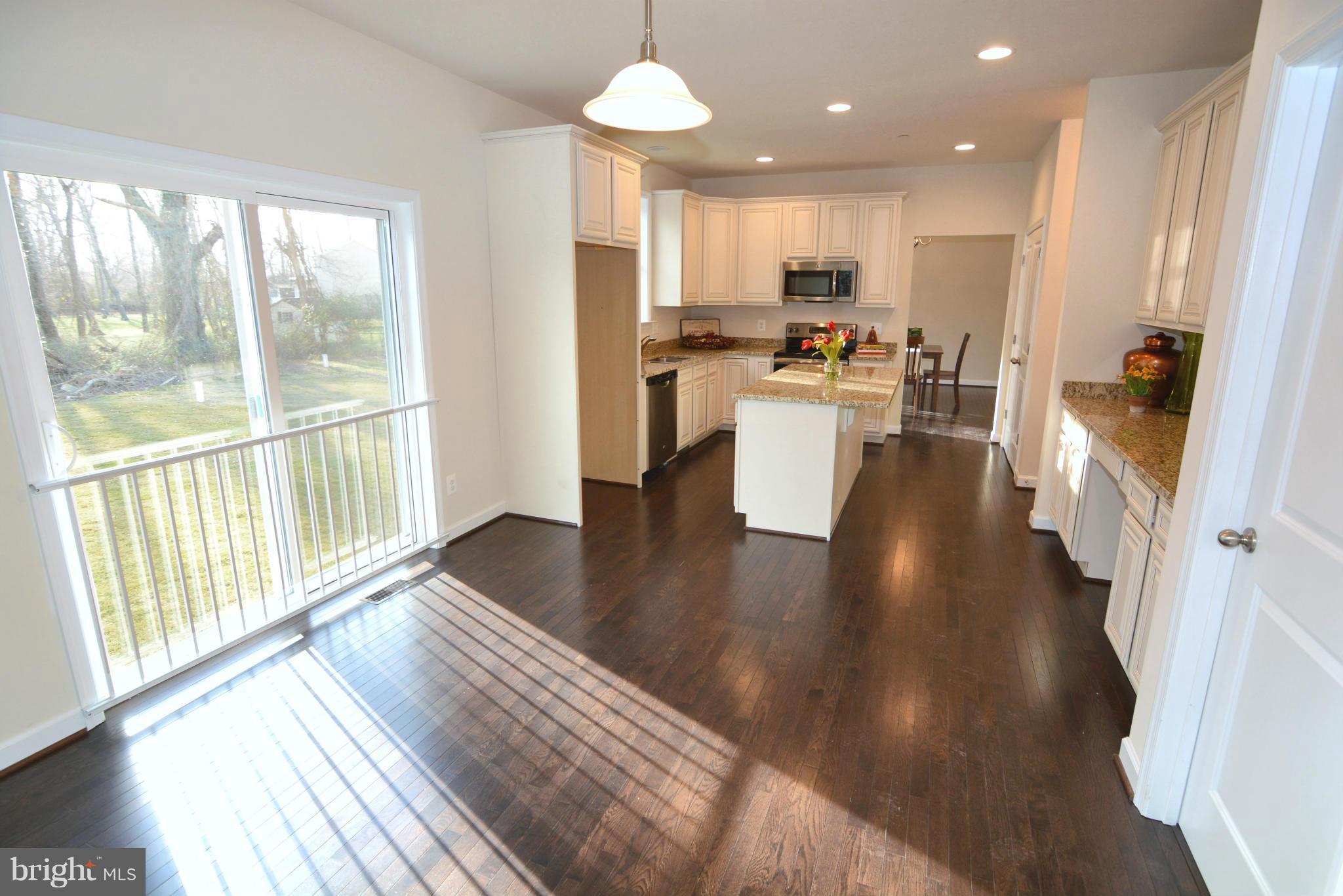 1217 Shesley Road Mayo, MD 21037 - Photo 11 of 30 a view of a kitchen with stove and wooden floor