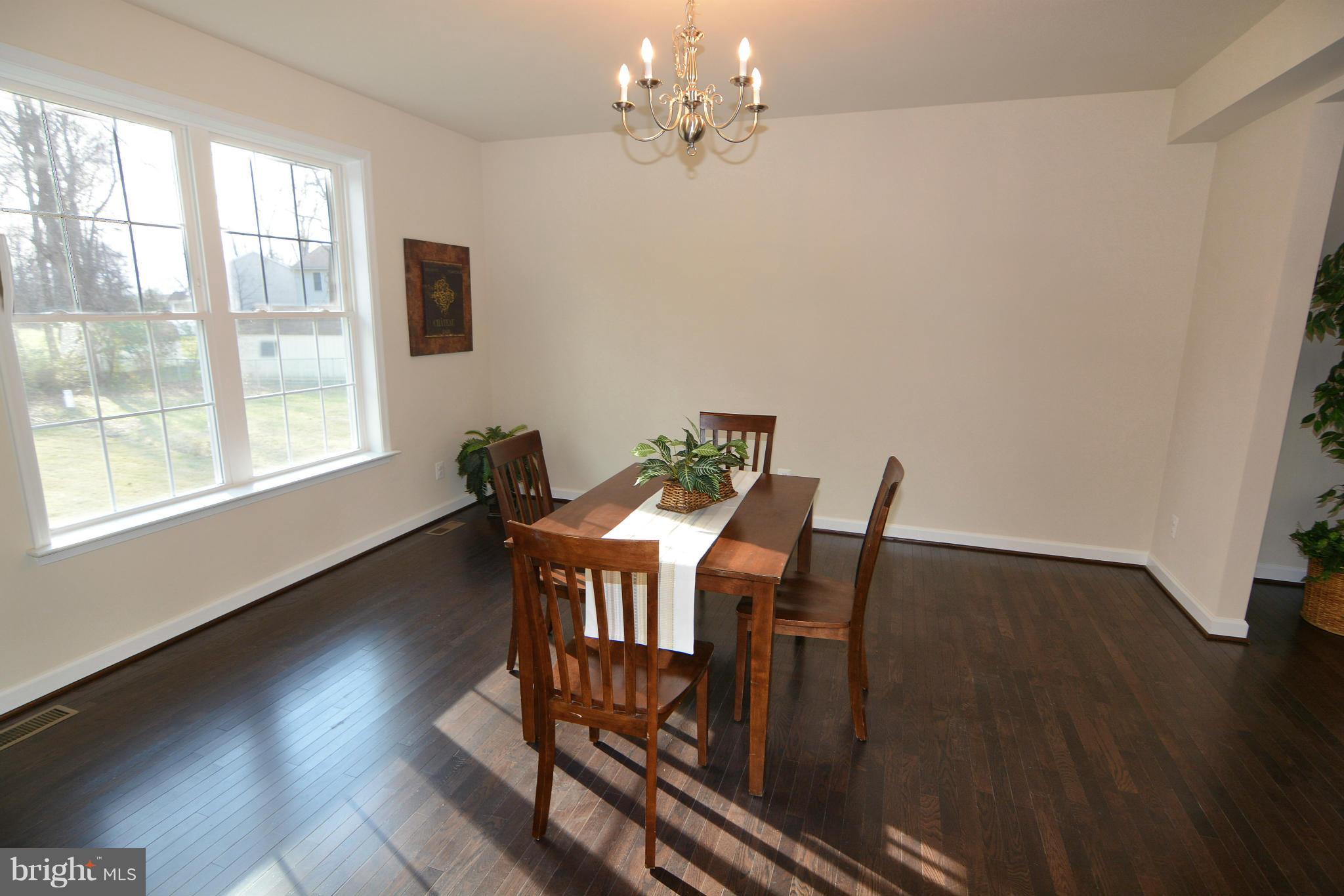 1217 Shesley Road Mayo, MD 21037 - Photo 6 of 30 a view of a dining room with furniture a chandelier and wooden floor