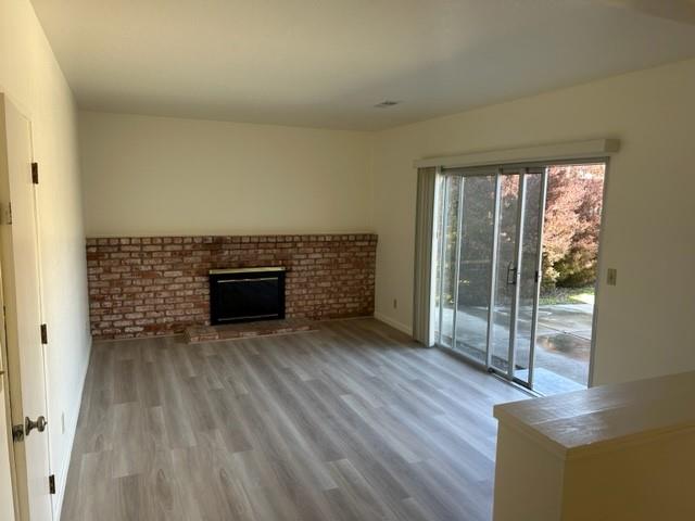 4479 Ranchero Drive Soquel, CA 95073 - Photo 2 of 11 wooden floor in an empty room with a fireplace