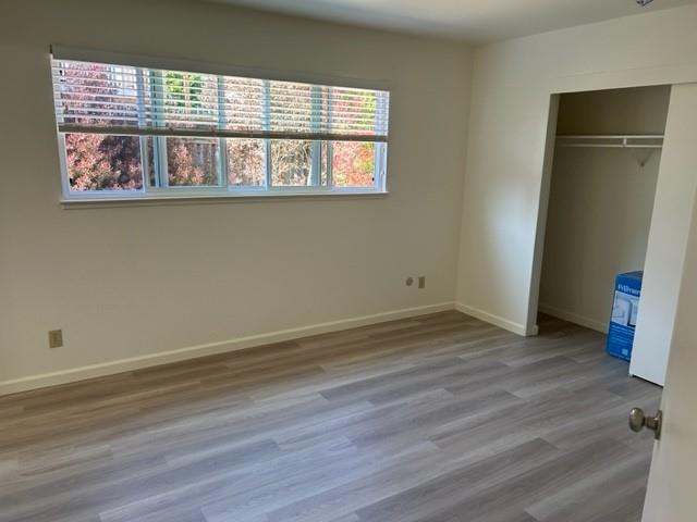 4479 Ranchero Drive Soquel, CA 95073 - Photo 9 of 11 an empty room with wooden floor and windows