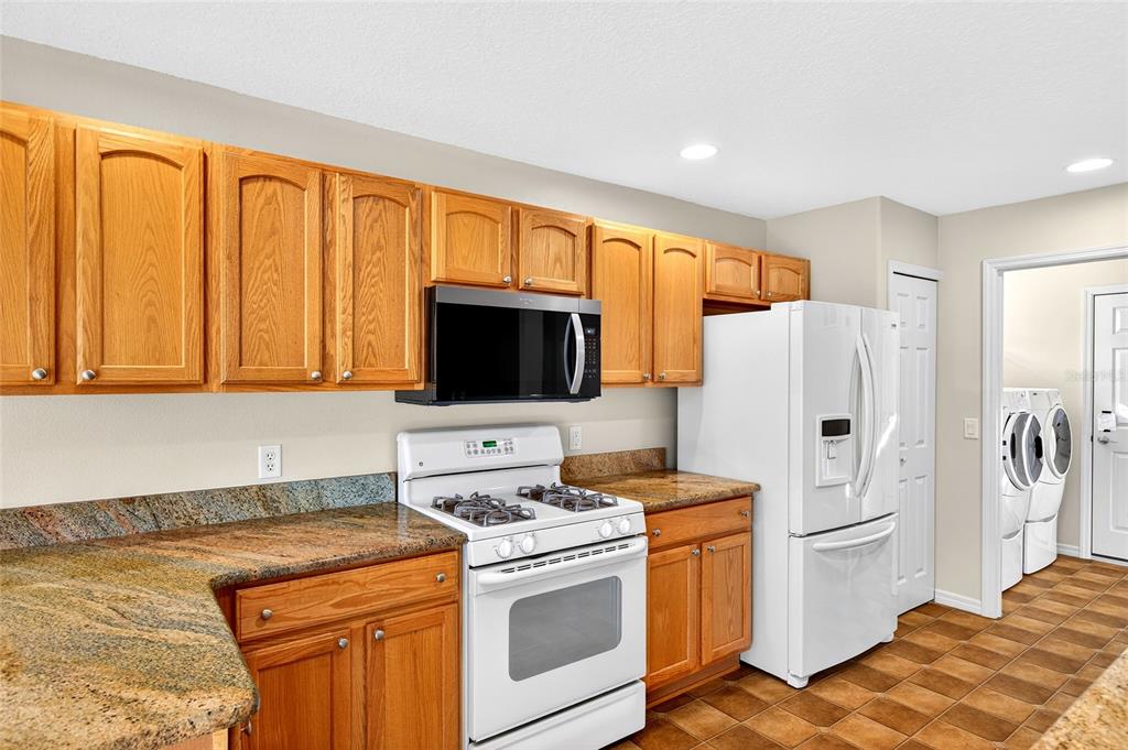 1706 Southwest 156th Lane Ocala, FL 34473 - Photo 12 of 44 a kitchen with stainless steel appliances granite countertop a refrigerator stove and sink