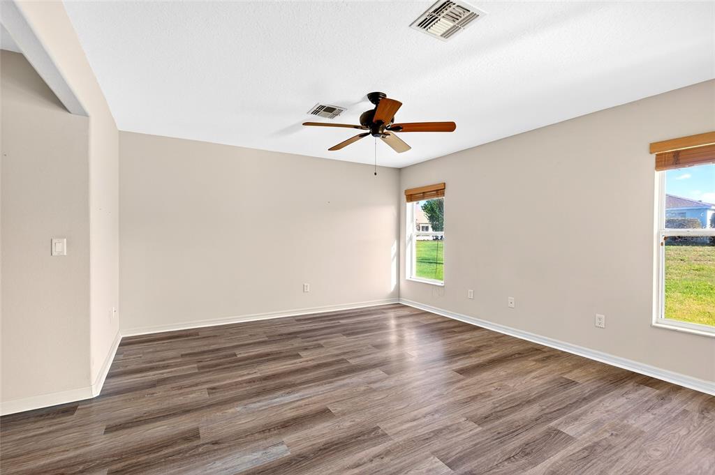 1706 Southwest 156th Lane Ocala, FL 34473 - Photo 16 of 44 an empty room with wooden floor and windows