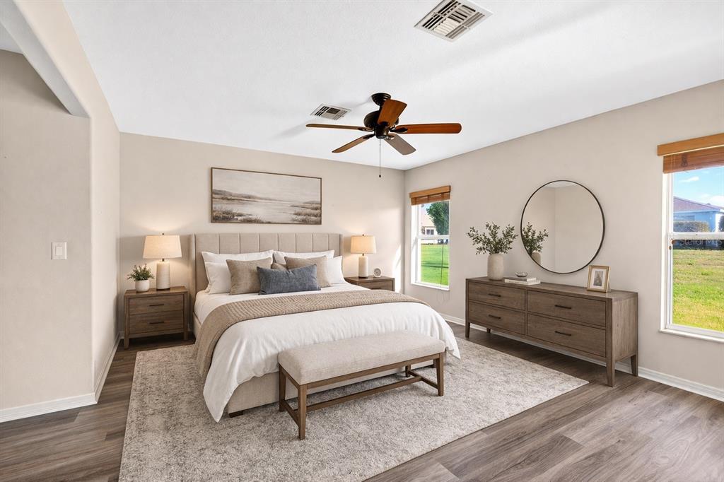 1706 Southwest 156th Lane Ocala, FL 34473 - Photo 17 of 44 a bedroom with a bed a chandelier and dresser