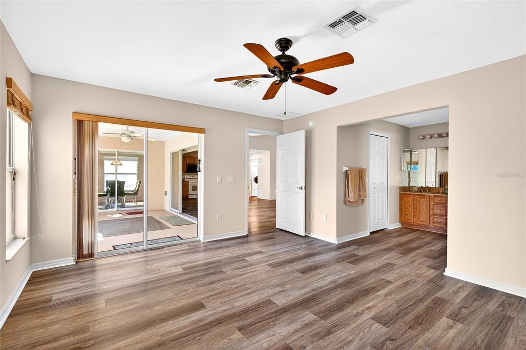 1706 Southwest 156th Lane Ocala, FL 34473 - Photo 18 of 44 a view of a livingroom with wooden floor and a ceiling fan