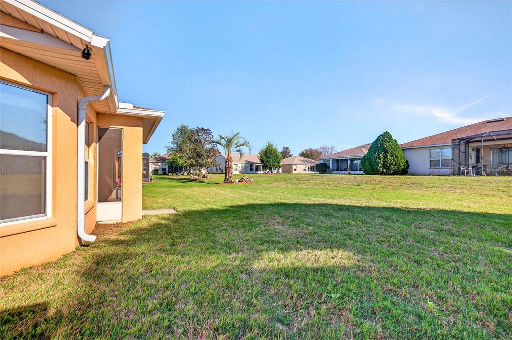 1706 Southwest 156th Lane Ocala, FL 34473 - Photo 30 of 44 a view of a house with a big yard and potted plants