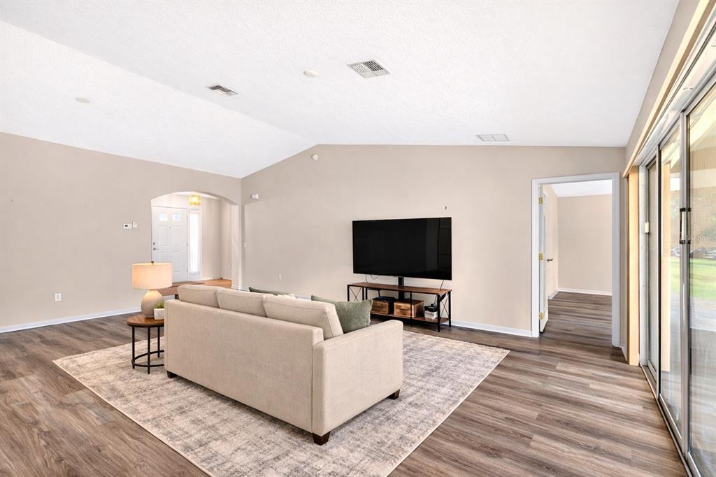 1706 Southwest 156th Lane Ocala, FL 34473 - Photo 6 of 44 a living room with furniture and a flat screen tv
