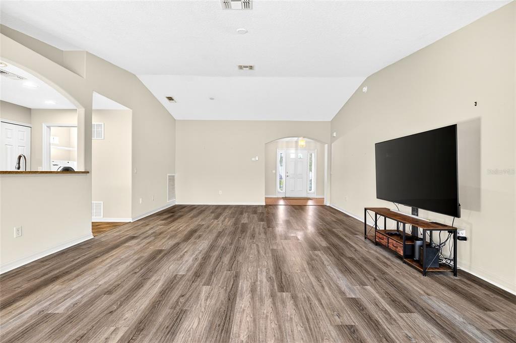 1706 Southwest 156th Lane Ocala, FL 34473 - Photo 7 of 44 a view of a livingroom with wooden floor and a flat screen tv