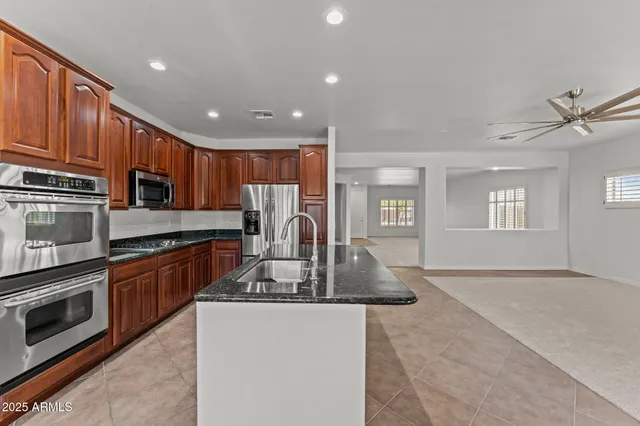 a kitchen with wooden cabinets and stainless steel appliances