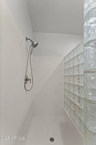 a spacious bathroom with a double vanity sink a and a large mirror