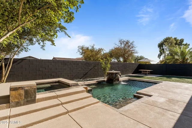 a view of a grey house with a yard