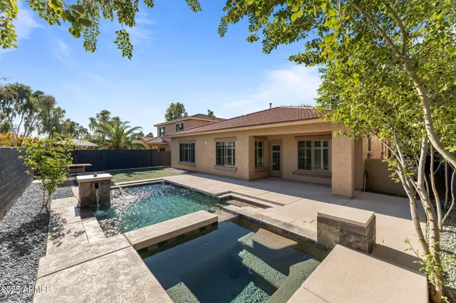 a view of a backyard with sitting area