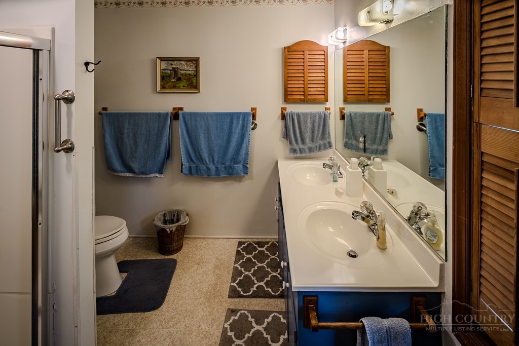 107-109 Shagbark Road Beech Mountain, NC 28604 - Photo 30 of 45 a bathroom with a sink and a mirror
