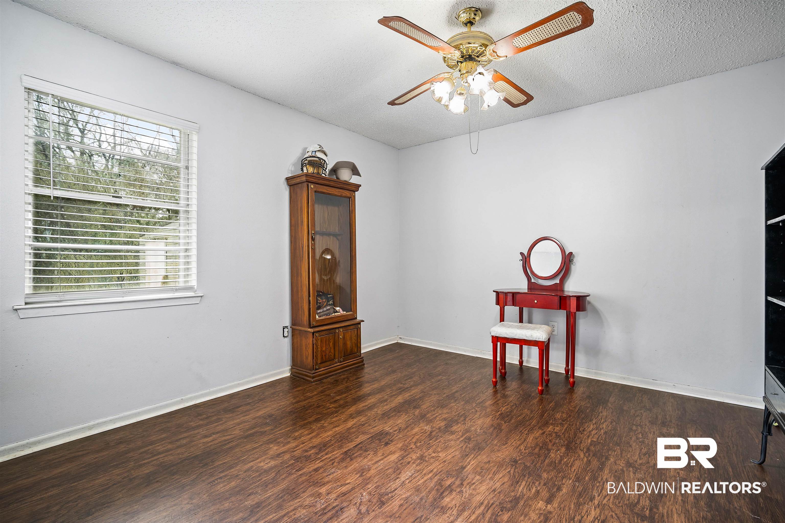 5110 Wilmer Road Wilmer, AL 36587 - Photo 12 of 24 Interior space with ceiling fan, dark wood-type flooring, and a textured ceiling