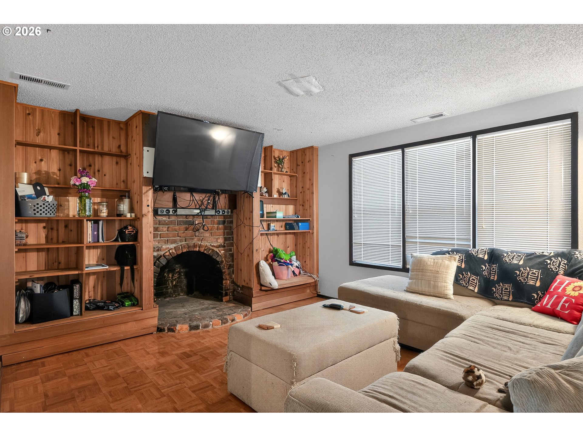 840 South 1st Street Cottage Grove, OR 97424 - Photo 11 of 39 a living room with furniture a fireplace and a floor to ceiling window