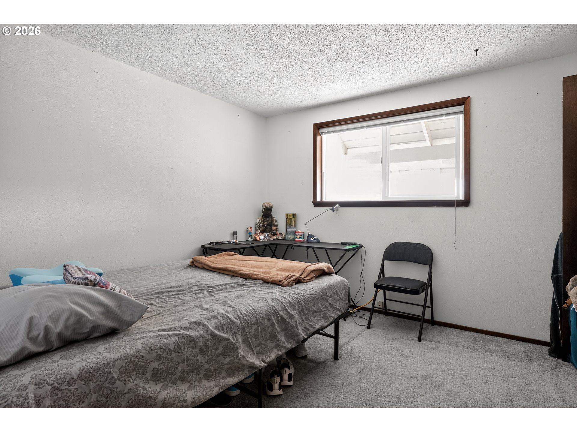 840 South 1st Street Cottage Grove, OR 97424 - Photo 25 of 39 a bedroom with a bed and a chair