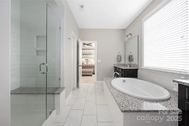 a bathroom with a tub and window