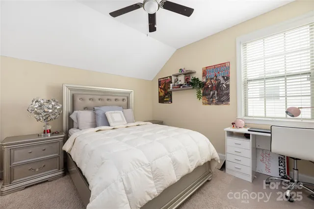 a bedroom with a bed and a desk