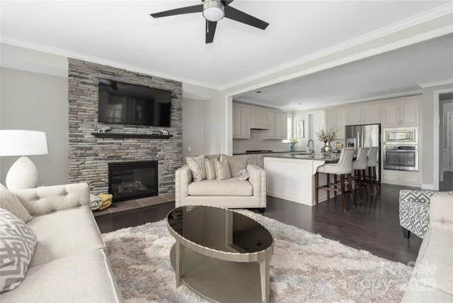 a living room with furniture a fireplace and a flat screen tv