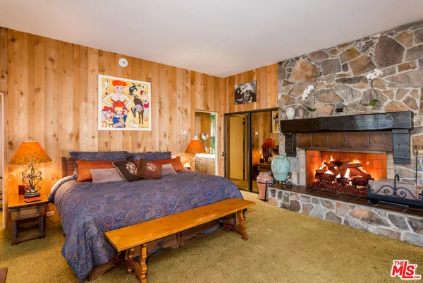 a room with fireplace furniture and a floor to ceiling window