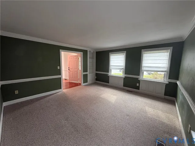 a large kitchen with stainless steel appliances a large counter top a stove and a refrigerator