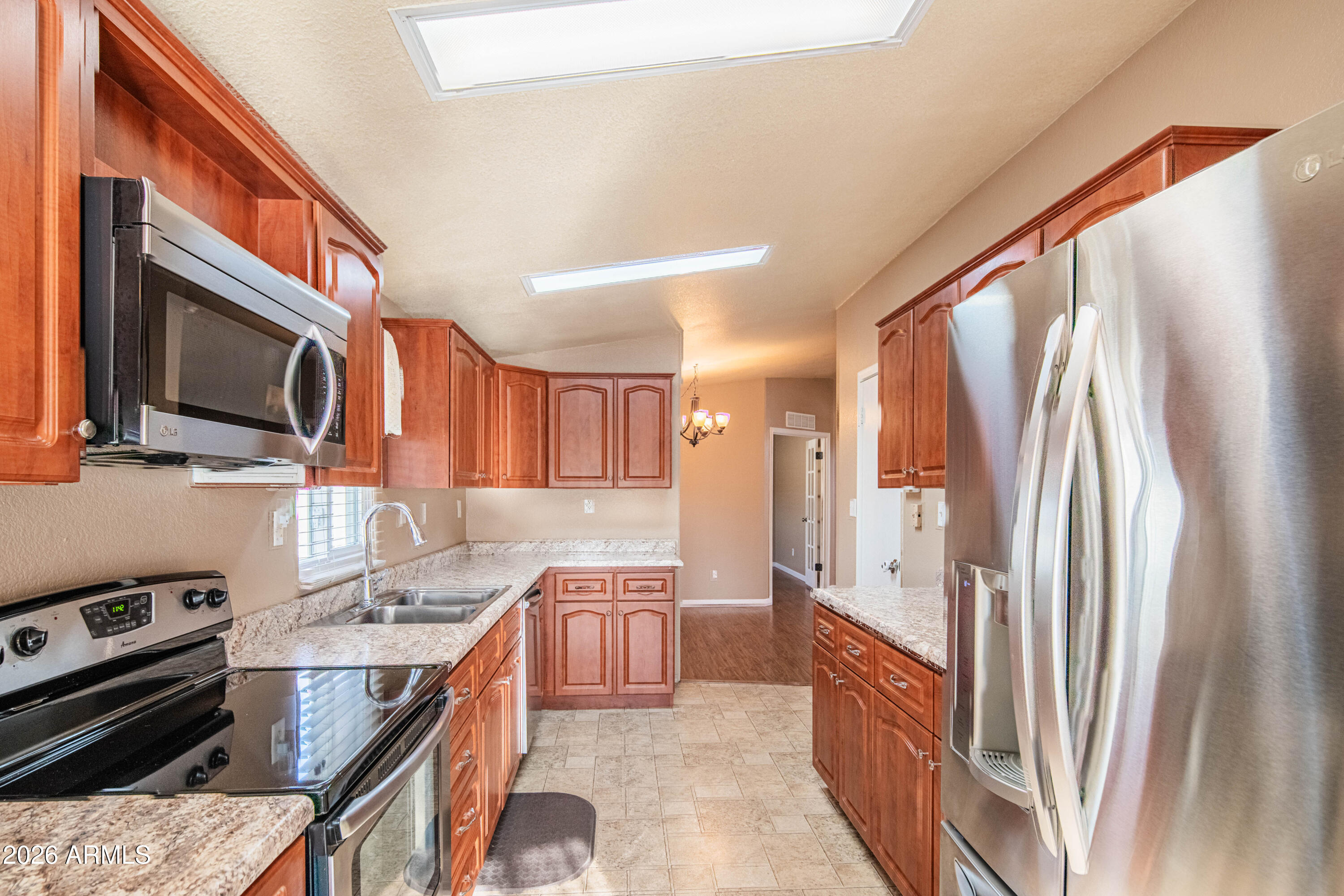 633 South 87th Place Mesa, AZ 85208 - Photo 32 of 55 a kitchen with stainless steel appliances granite countertop a refrigerator a stove top oven a sink and dishwasher
