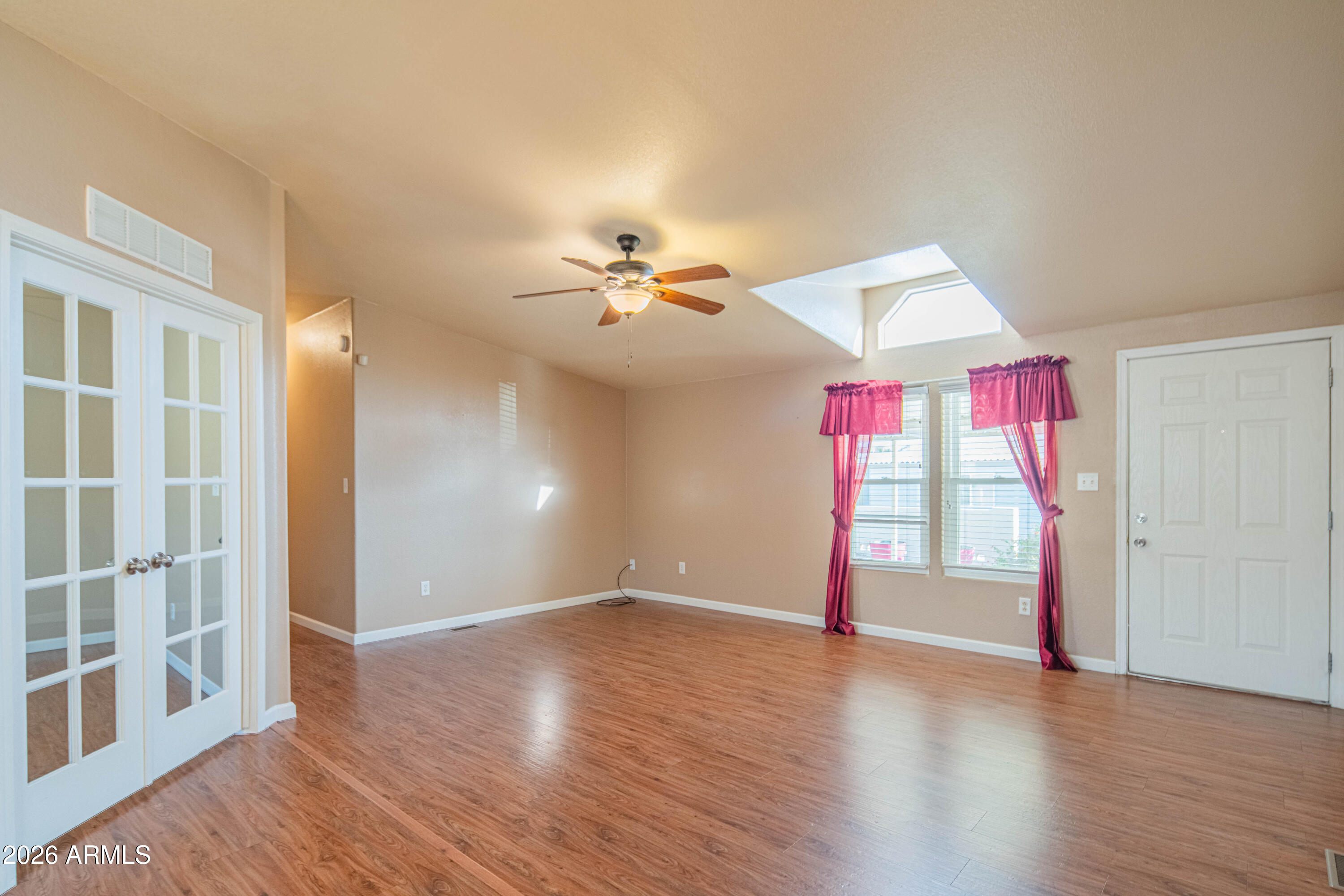 633 South 87th Place Mesa, AZ 85208 - Photo 37 of 55 a view of empty room with wooden floor and fan