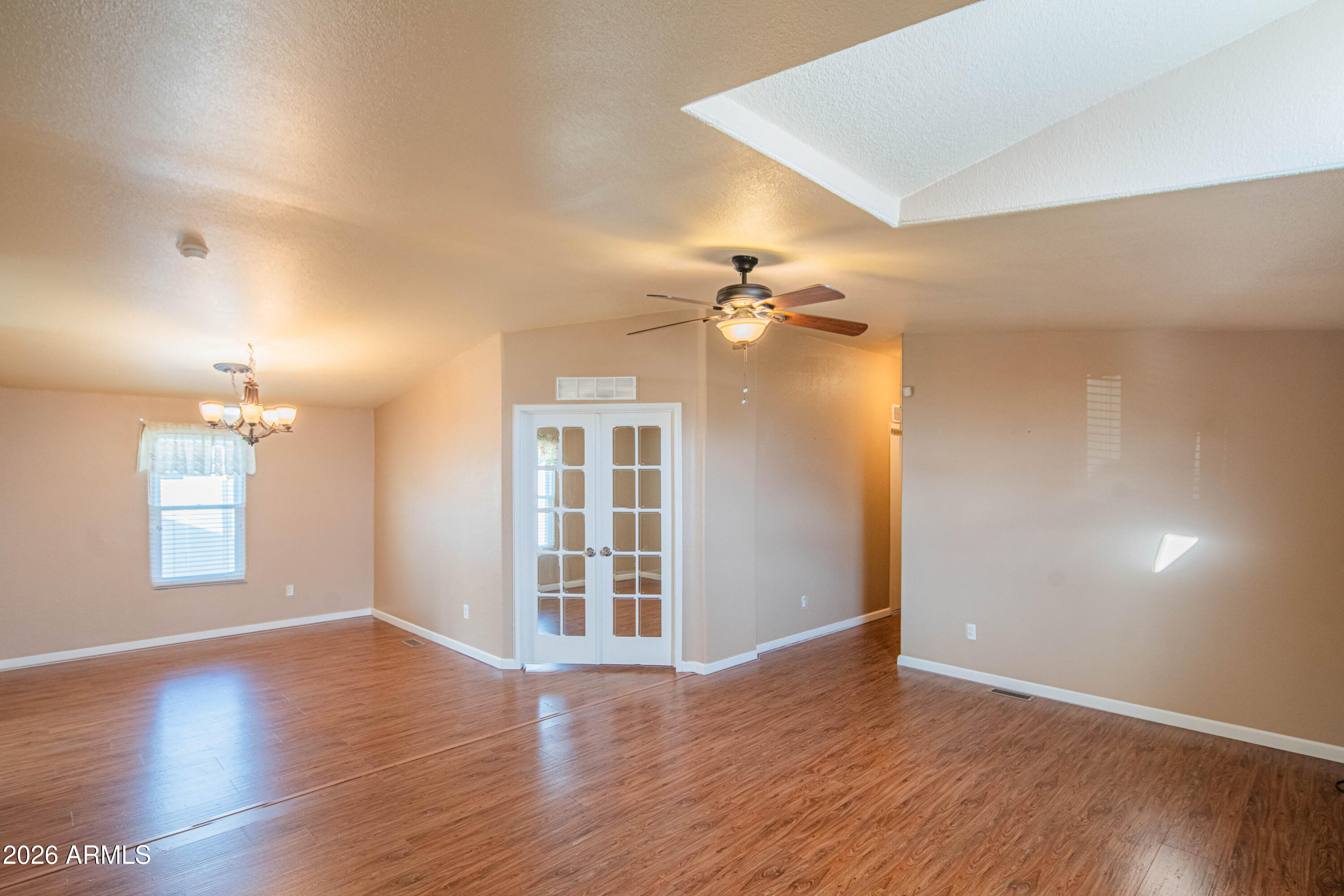633 South 87th Place Mesa, AZ 85208 - Photo 38 of 55 an empty room with wooden floor and windows