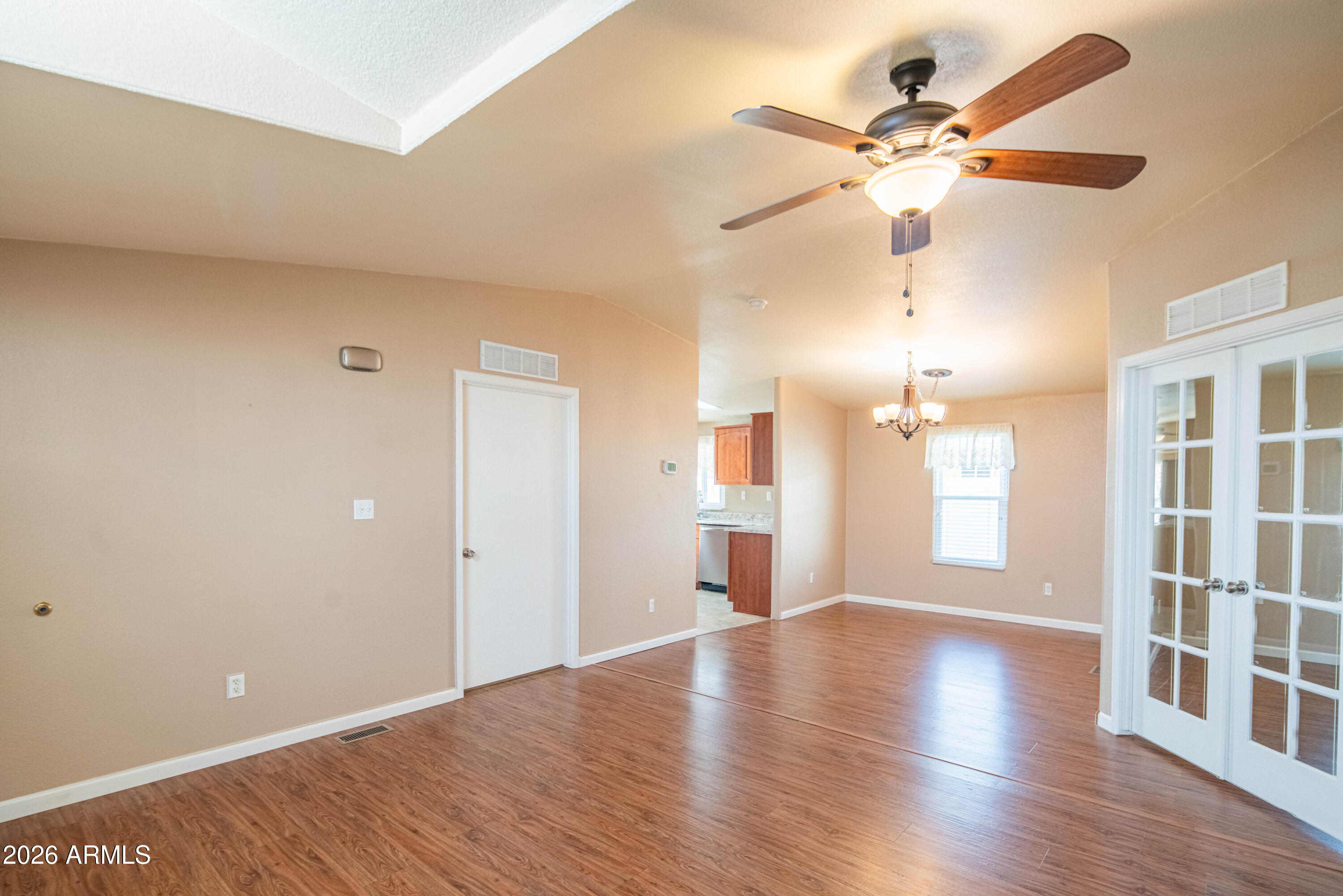 633 South 87th Place Mesa, AZ 85208 - Photo 40 of 55 a view of an empty room with a window and wooden floor