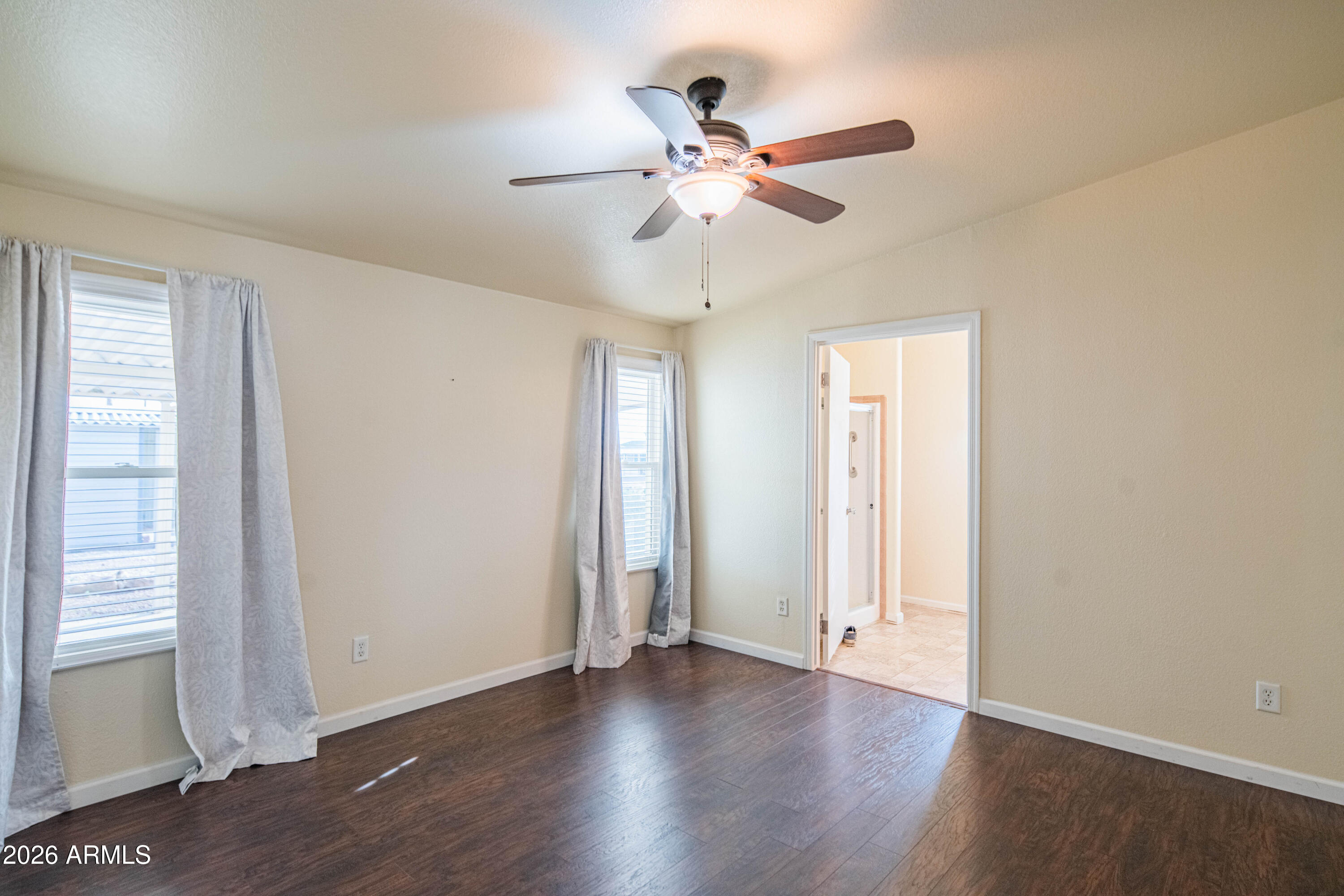633 South 87th Place Mesa, AZ 85208 - Photo 46 of 55 an empty room with wooden floor fan and windows