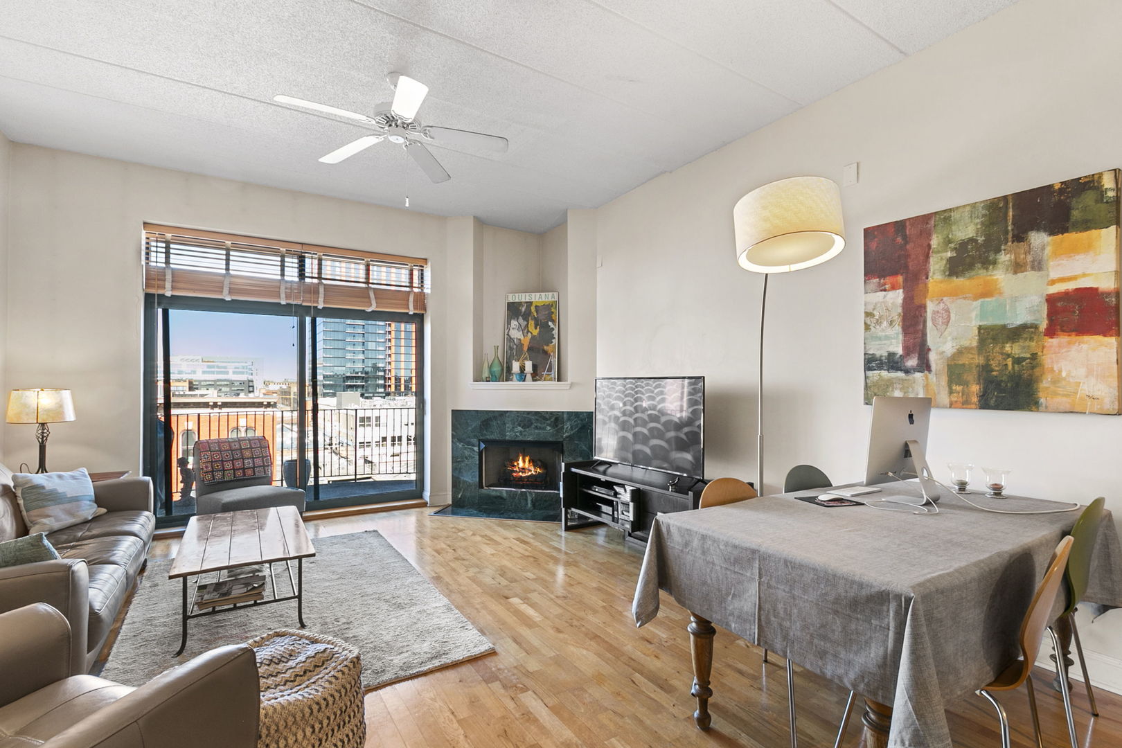 1301 West Washington Boulevard, Unit 508 Chicago, IL 60607 - Photo 3 of 17 a living room with furniture a fireplace and a floor to ceiling window