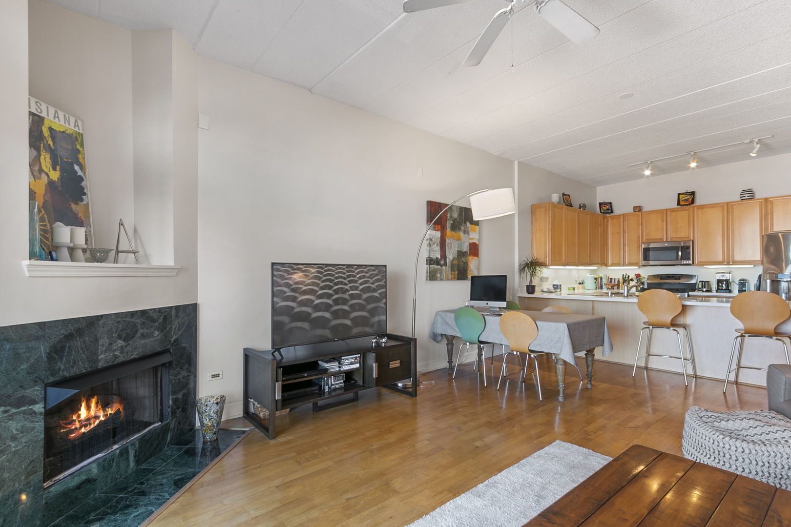 1301 West Washington Boulevard, Unit 508 Chicago, IL 60607 - Photo 4 of 17 a living room with furniture and a fireplace