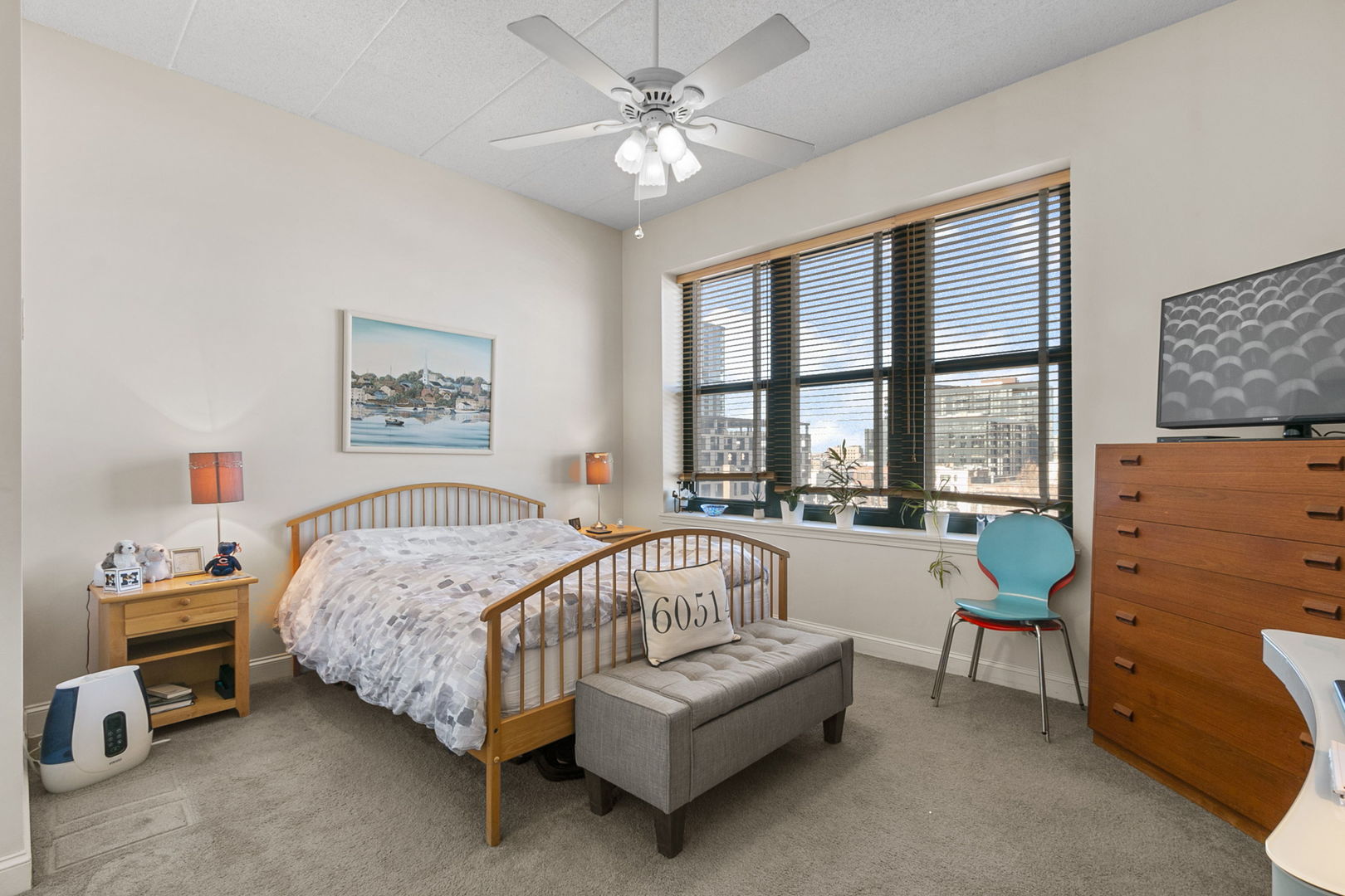 1301 West Washington Boulevard, Unit 508 Chicago, IL 60607 - Photo 9 of 17 a spacious bedroom with a bed a couch and a window