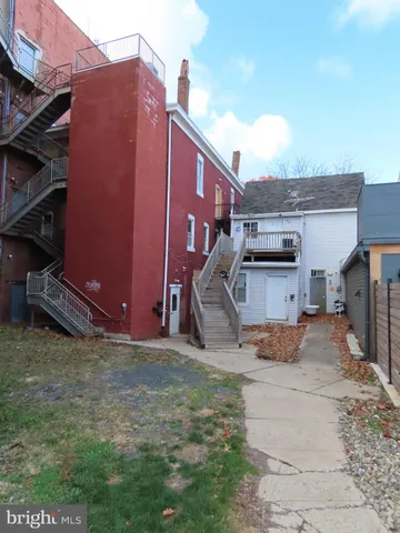 a backyard of a house with barbeque oven table and chairs