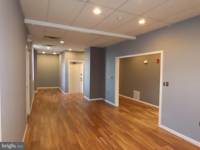 a view of hallway with wooden floor