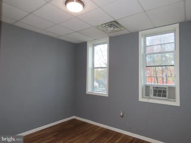 a view of a room with wooden floor and windows