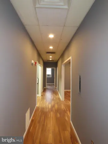 a view of hallway with wooden floor