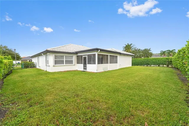 a view of a house with a backyard